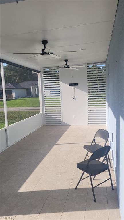 Screened patio with light-toned tiled flooring
