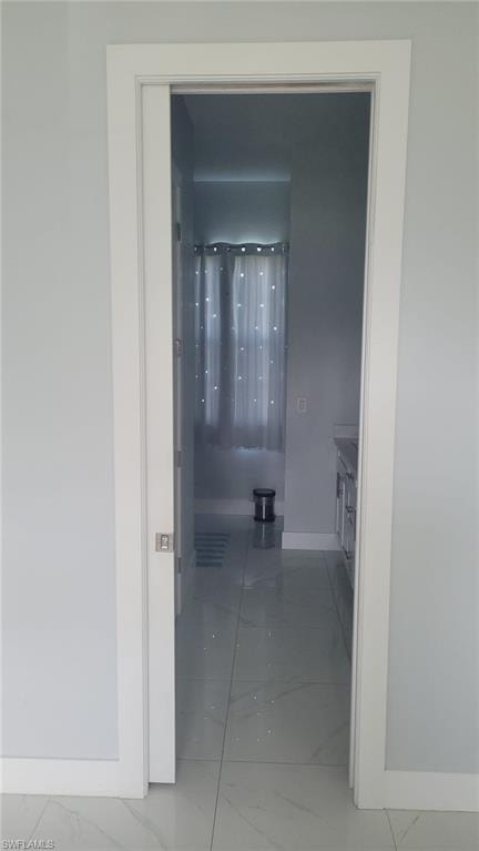 Pocket door entry featuring white trim and a satin nickel handle