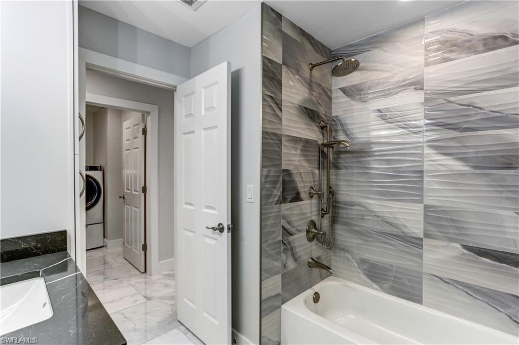 Guest bathroom located next to back guest bedroom with custom tile.