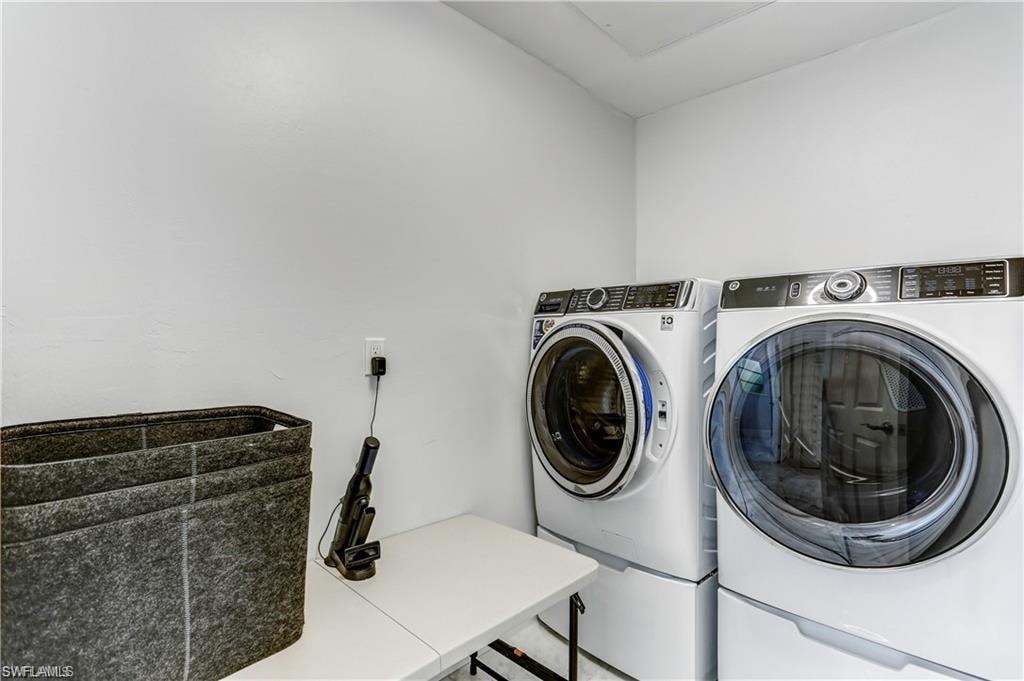 Separate laundry room with  G.E. elevated washer and dryer.