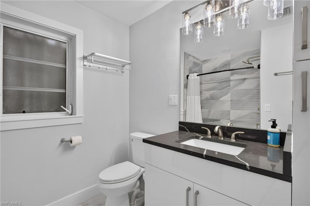 Guest bath with quartz counters, new vanity, lighting, plumbing fixtures.