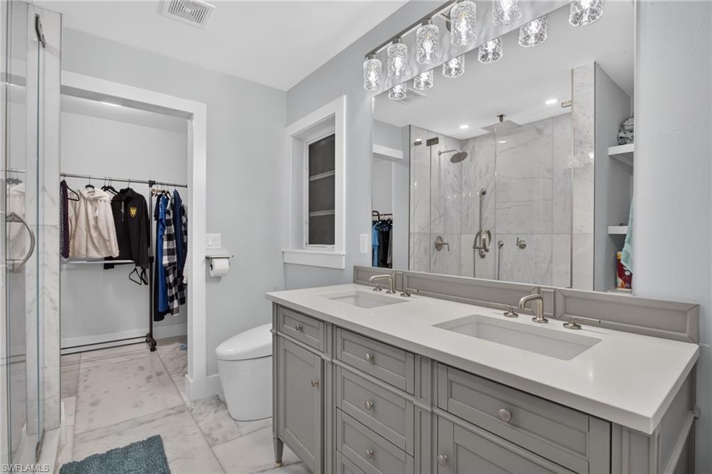 Dual sink vanity, quartz counters. Toto bidet toilet, new lighting, plumbing, and electrical fixtures.
