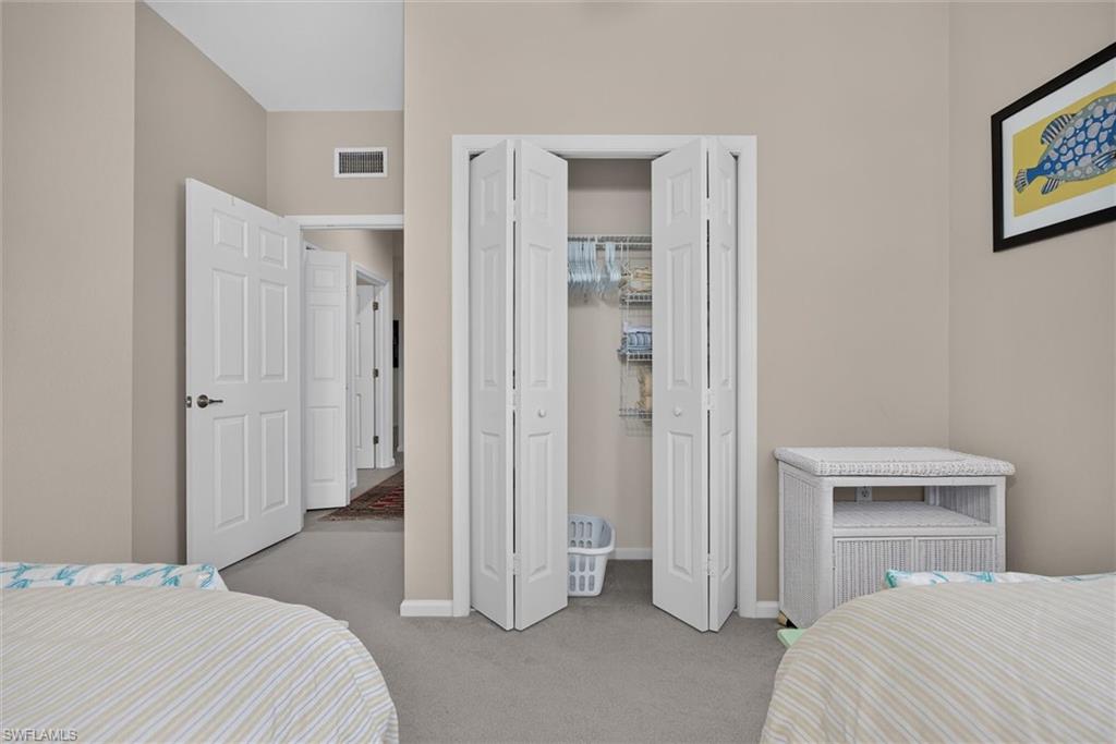 Bedroom featuring light beige walls and gray carpet flooring
