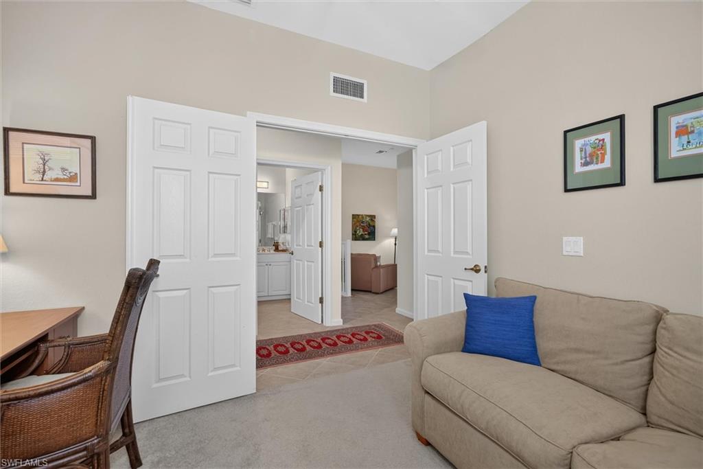 Versatile interior space featuring vaulted ceilings, neutral wall tones, and carpet flooring
