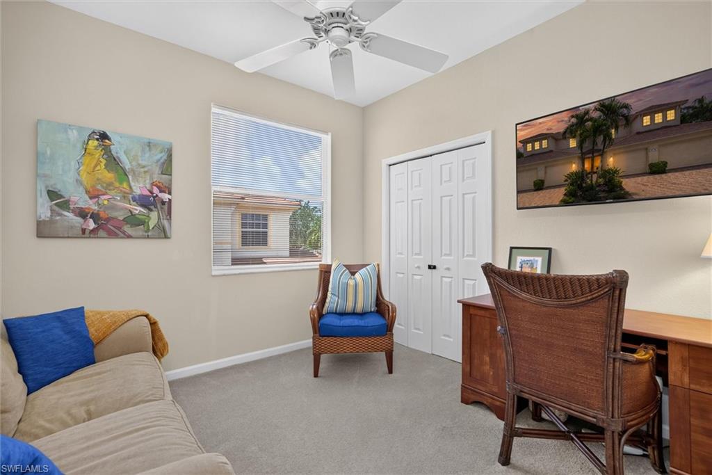 Bright room featuring neutral wall paint, carpet flooring, a ceiling fan, a window with horizontal blinds, and bi-fold closet doors