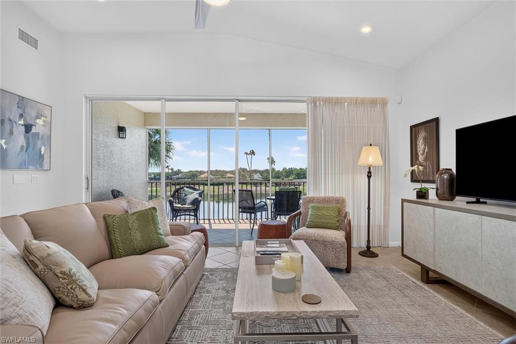 Living area featuring vaulted ceilings, recessed lighting, and a ceiling fan