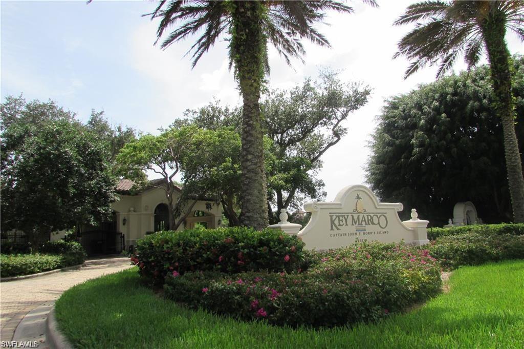 "Key Marco" stone entry monument surrounded by mature landscaping