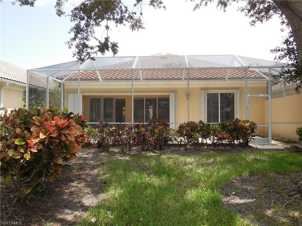 Screened enclosure with tile roofline and neutral stucco exterior