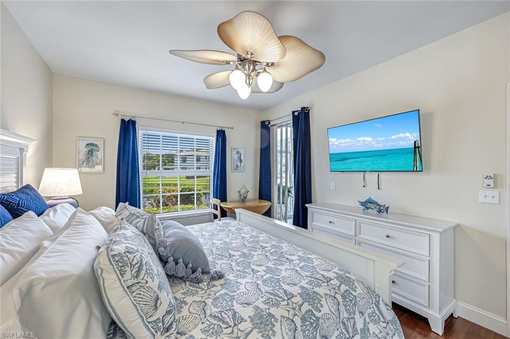 Bedroom with dark wood-style flooring and ceiling fan