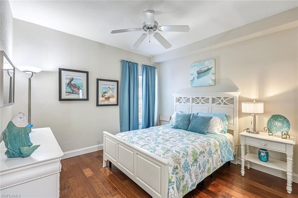 Bedroom with dark wood-type flooring and a ceiling fan