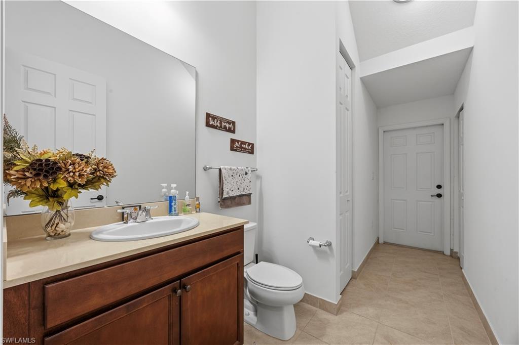 Large powder room on first floor with entrance/exit to side of house