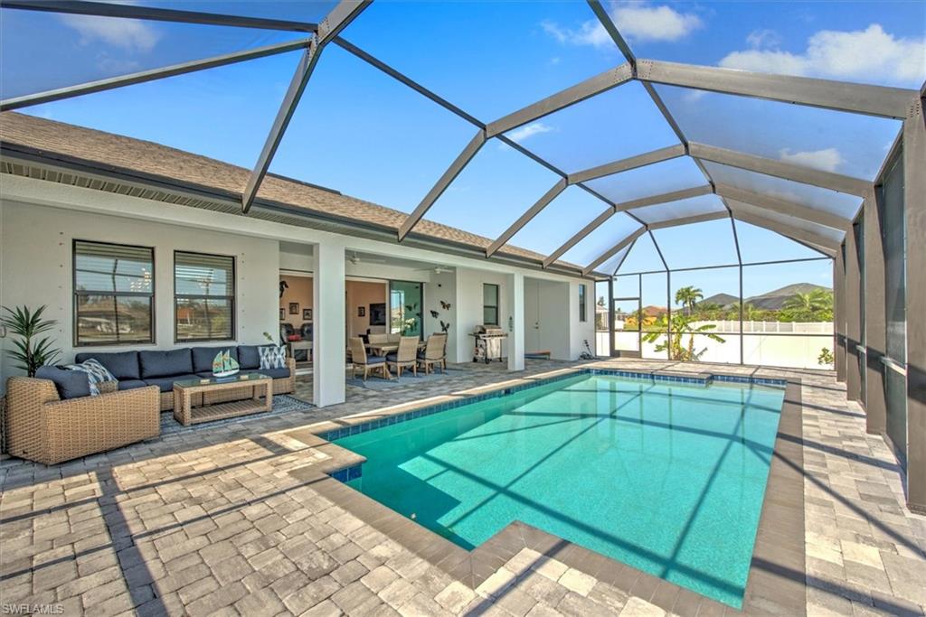View of swimming pool with a lanai, an outdoor hangout area, and a patio