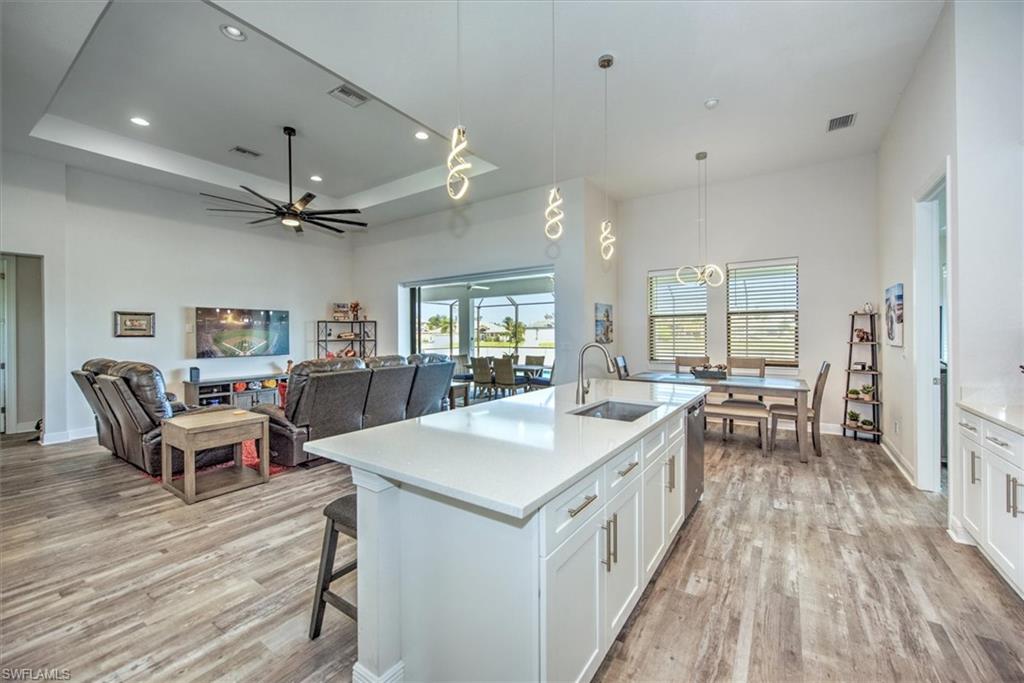 Kitchen featuring sink, light hardwood / wood-style floors, and white cabinetry