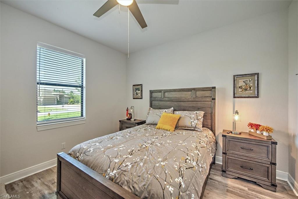 Bedroom with hardwood / wood-style flooring and ceiling fan
