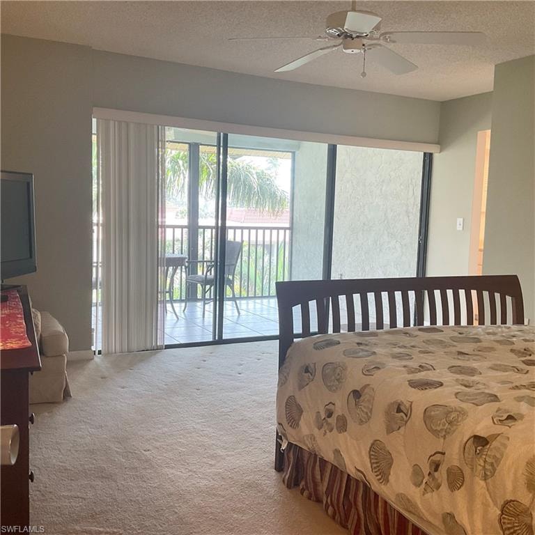 Primary bedroom with ceiling fan, carpet, access to exterior lanai