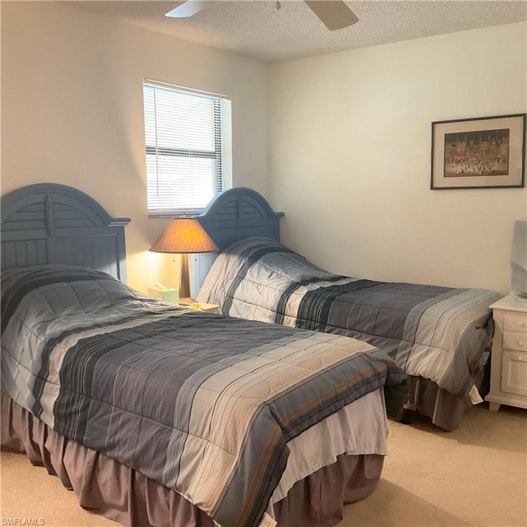 Guest bedroom with ceiling fan, carpet