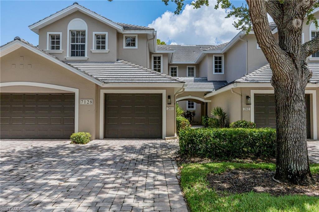 Tranquil tree lined street with attached garage
