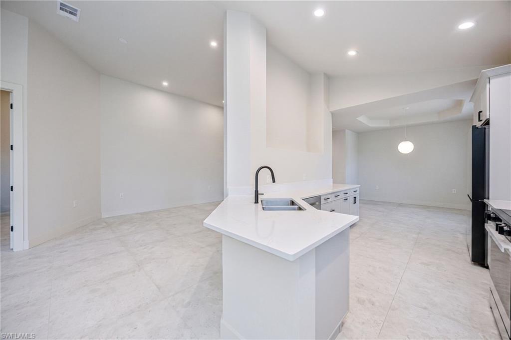 The beautifully updated kitchen features brand-new quartz countertops with a sleek, modern finish