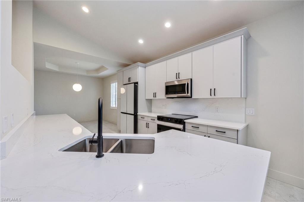 The newly remodeled kitchen and entire home features new modern lighting, creating a sophisticated and welcoming environment