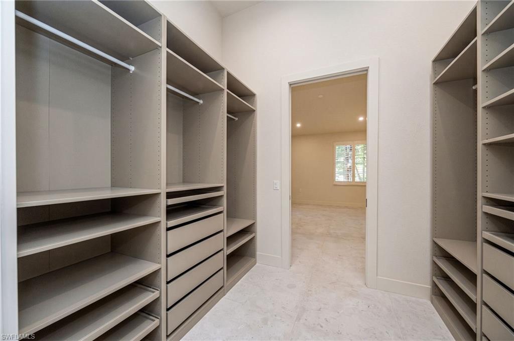 Spacious primary closet reimagined with enhanced organization and a luxurious, boutique feel