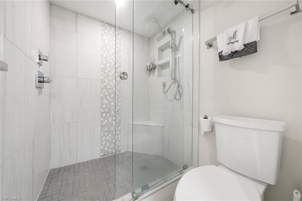 Bathroom with a shower with door and toilet
