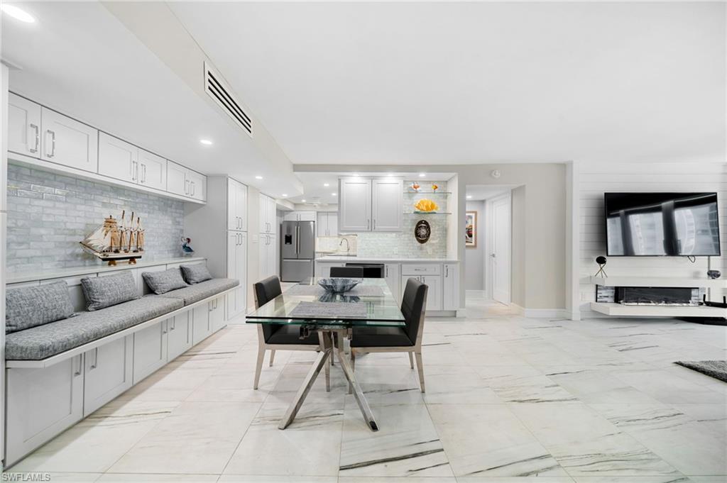 Tiled dining area featuring sink