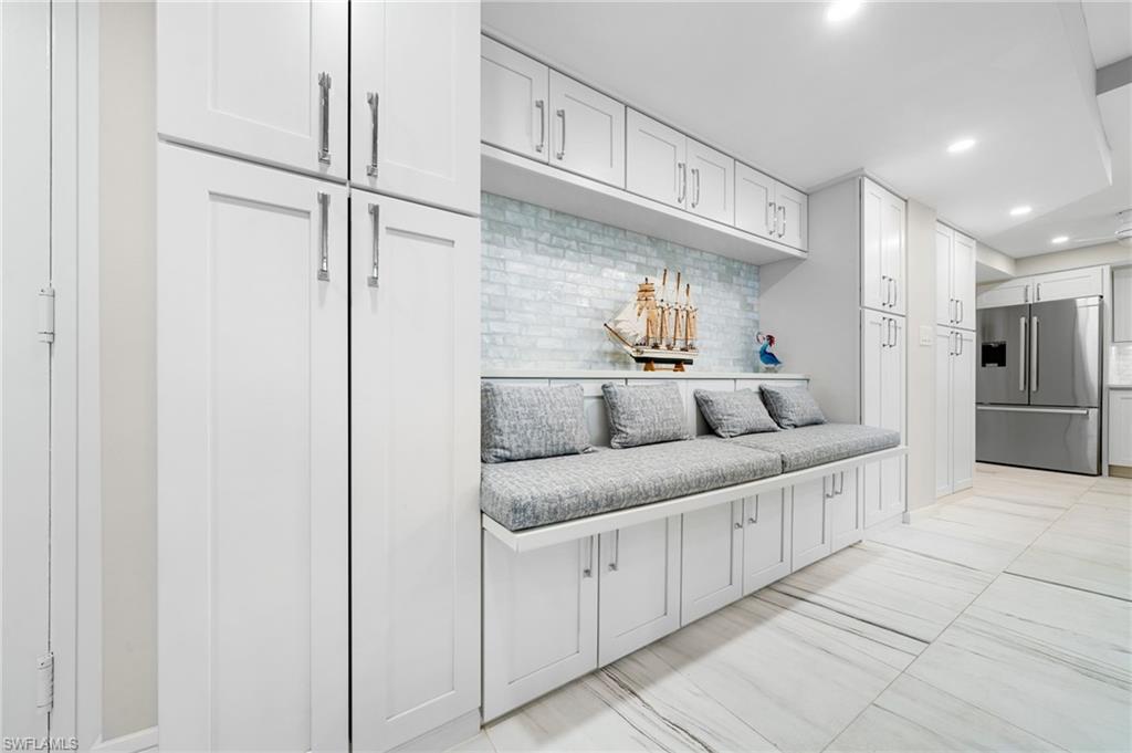 Mudroom with light tile patterned flooring