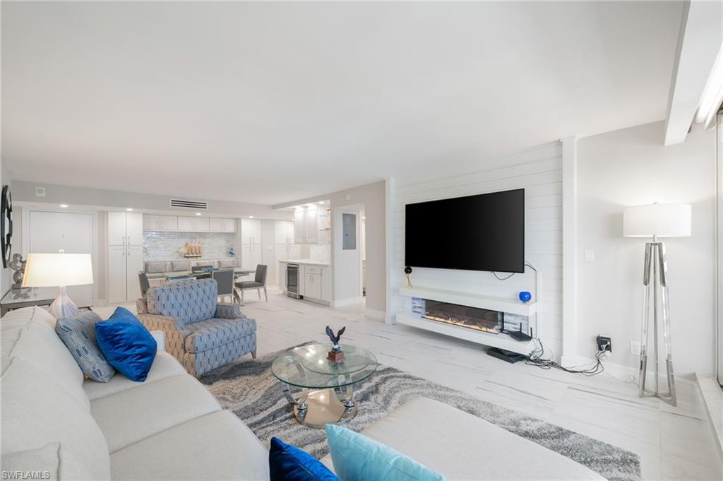 Tiled living room featuring wine cooler and a fireplace