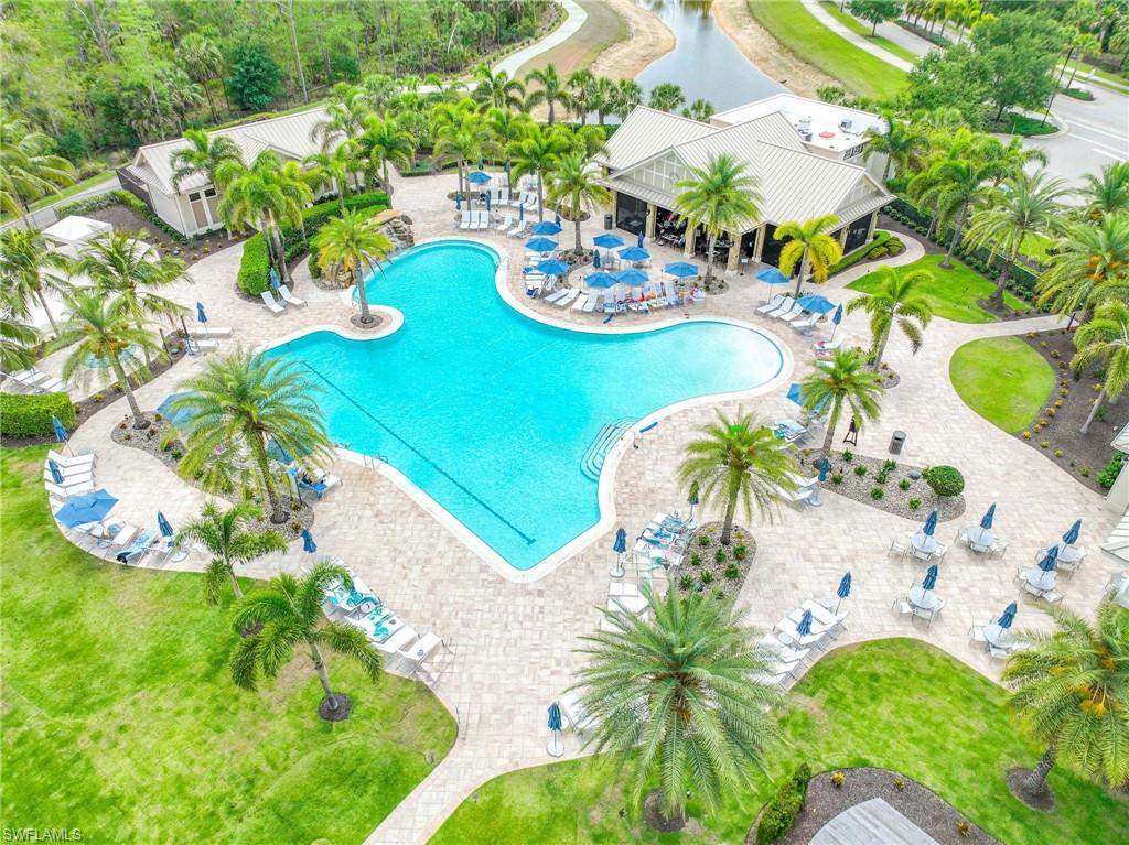 Expansive resort-style swimming pool featuring a free-form design with 2 lap swimming lanes, integrated spa, and ample surrounding patio space