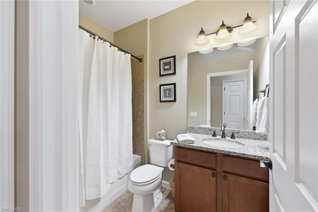 Guest Bathroom featuring  granite countertop, undermount sink, tub and shower.