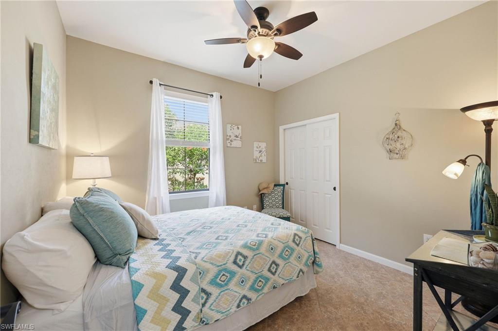 This is the second guest bedroom in the home, featuring a spacious  room  filled with abundant natural light streaming through the window,  a generous closet providing ample storage space and durable, low-maintenance tile flooring throughout the entire room.
