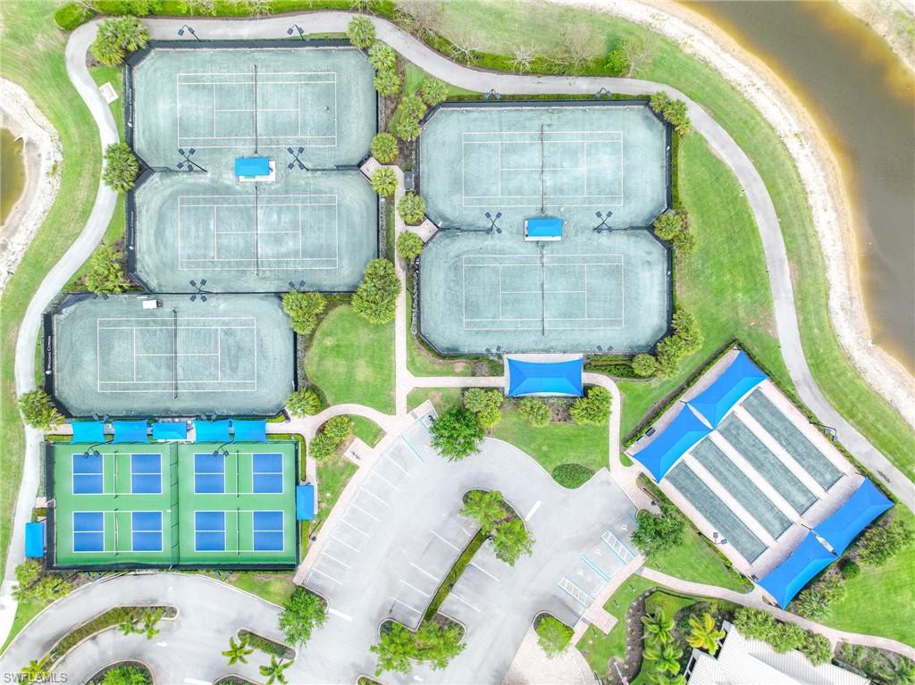 Tennis and pickleball courts surrounded by landscaped grounds and pedestrian pathways- 4 additional Pickleball courts coming soon