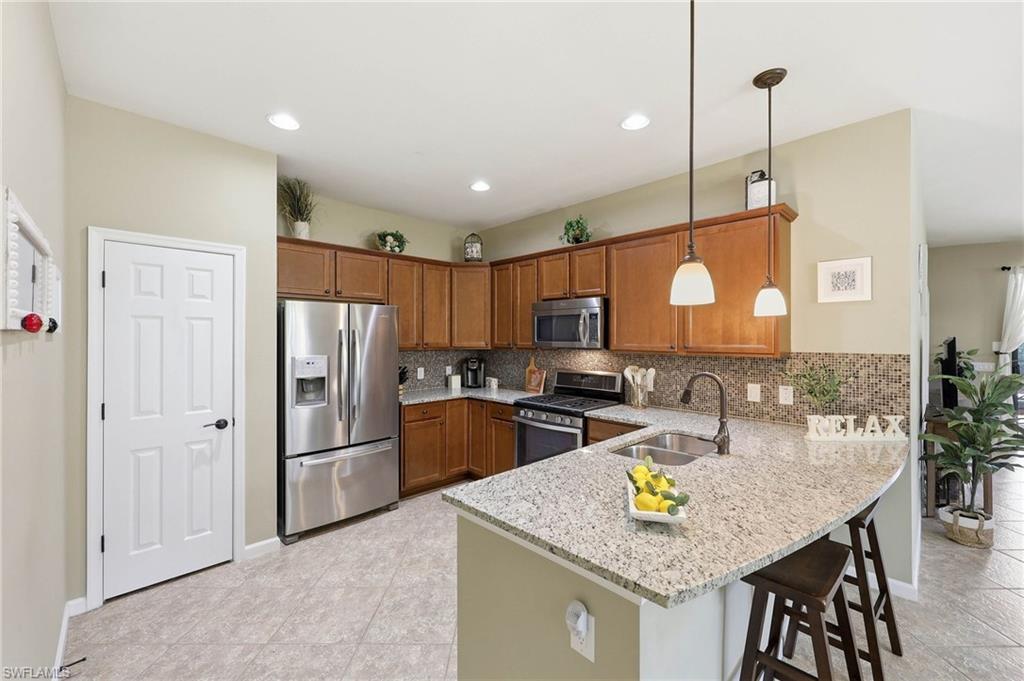 This kitchen features a functional layout adjacent to the dining area and great room, facilitating a seamless flow throughout the home.