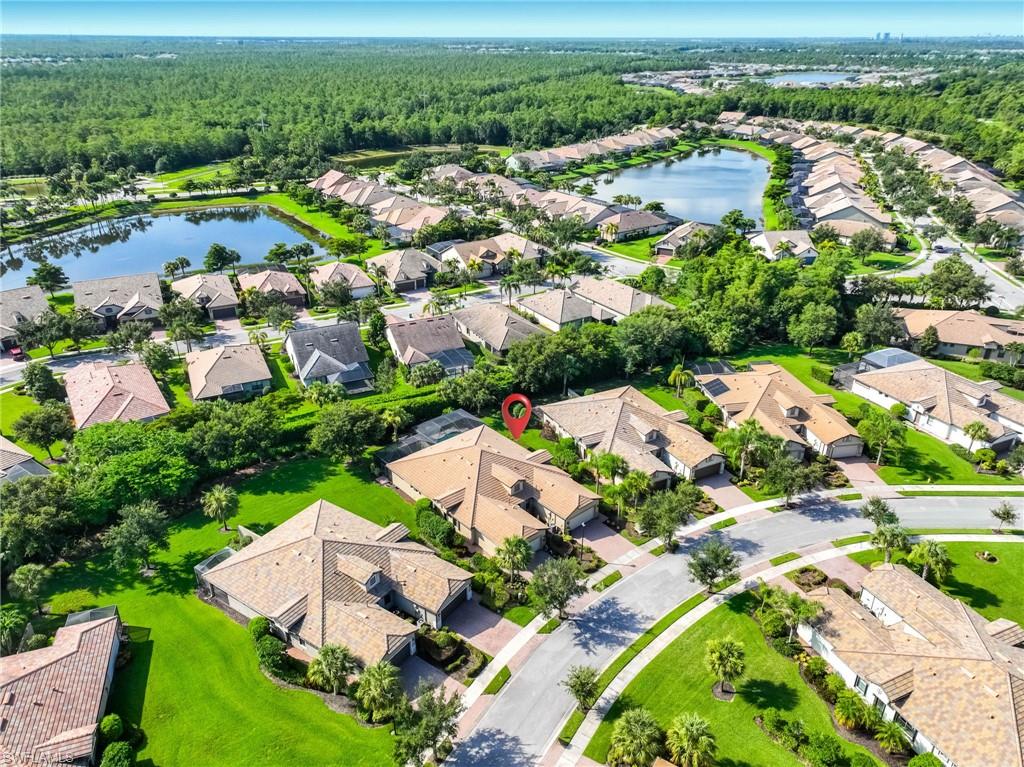 Aerial view of a residential community featuring, manicured lawns, and mature landscaping
