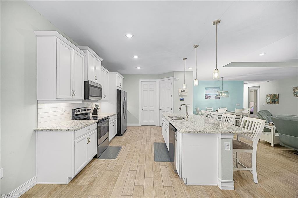Beautiful kitchen featuring stainless steel appliances, walk-in pantry, ample cabinetry, and modern finishes—perfect for buyers searching for a move-in-ready Cape Coral home.