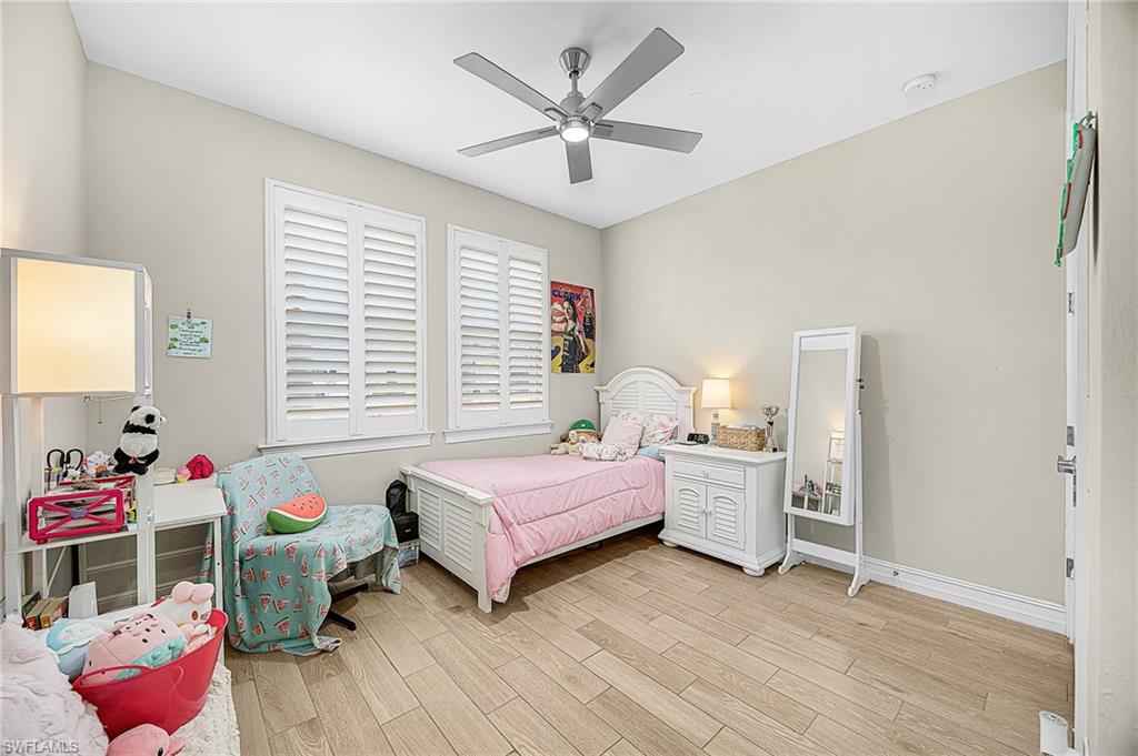 Spacious guest bedroom filled with natural light, offering comfort and privacy—perfect for visiting family, guests, or a secondary home office.