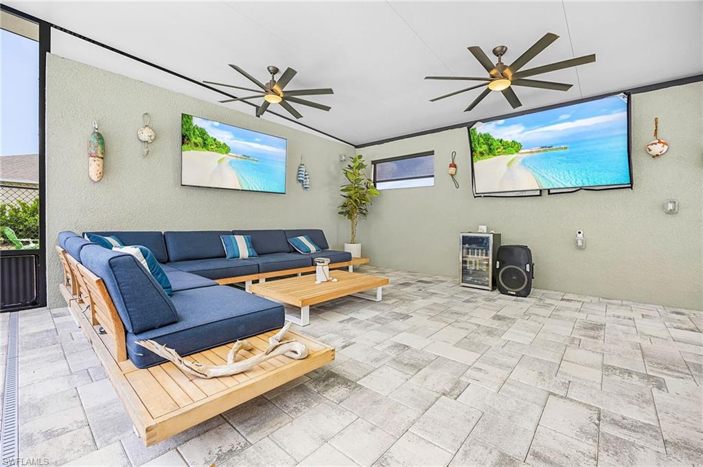 Outdoor living room complete with multiple TVs—perfect for game day, movie nights, or relaxing poolside in your private backyard oasis.  The perfect space to watch both games at once on Sunday!