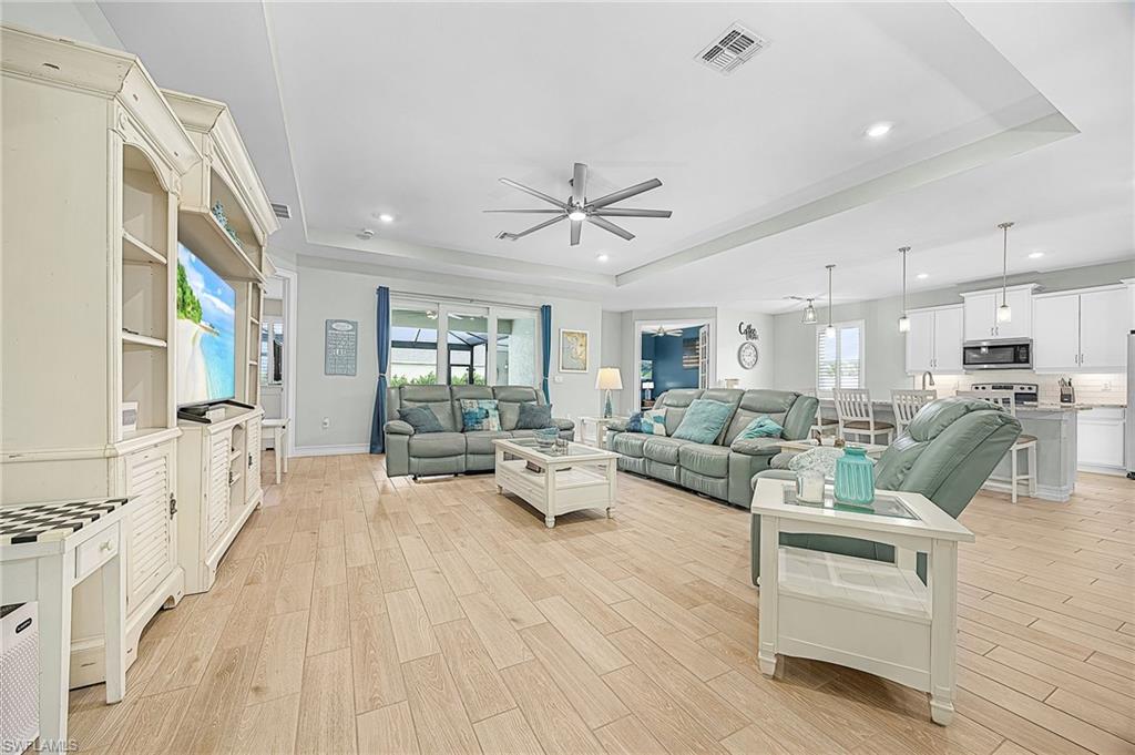 Tray ceilings, upgraded finishes, and expansive sliding glass doors create seamless indoor-outdoor living, a highly sought-after feature in Cape Coral pool homes.