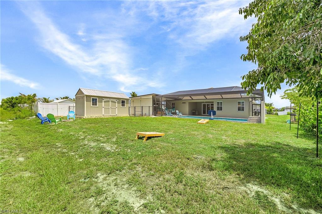 Firepit area with ample seating space, ideal for relaxing evenings, gatherings, or enjoying Southwest Florida’s beautiful weather.  200 sq ft shed offers extra storage to keep your garage clean and the yard has plenty of space for sports and games such as cornhole.