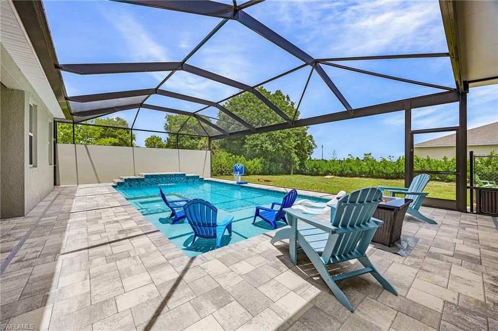 Plenty of room for two lounge chairs and several Adirondack chairs as shown here.  The oversized sun shelf is so much fun!  The Picture-window / panoramic screen enclosure frames the private backyard setting, maximizing views while maintaining protection from the elements.