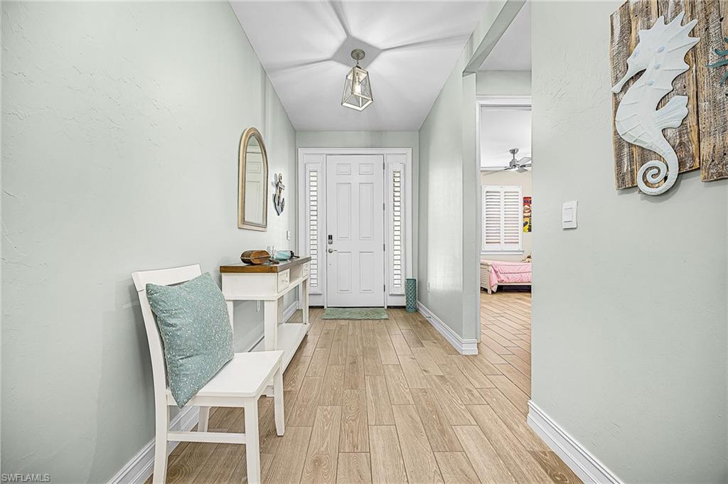 Elegant entry foyer with upgraded finishes, high ceilings, and open sightlines leading into the main living area, creating a bright and inviting first impression.