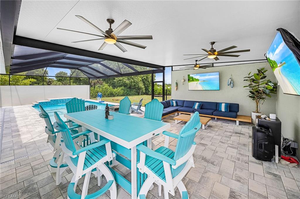 Massive outdoor screened in lanai area with both dining and lounge areas overlooking the pool and backyard, connecting everything together, perfect for indoor-outdoor entertaining.  Three oversized outdoor ceiling fans keep the covered lanai cool and comfortable year-round, enhancing the usability of this expansive outdoor space.
