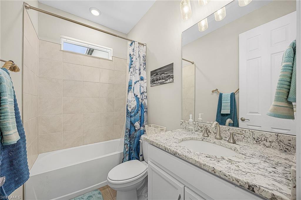 Third full bathroom with modern finishes, ideal for guests or convenient access from multiple areas of the home.  Easy access just around the corner from the sliders out to the pool.