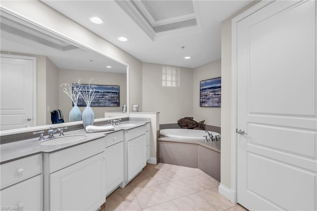 Main Ensuite Bathroom showing double sinks and soaking tub, private toilet door on right
