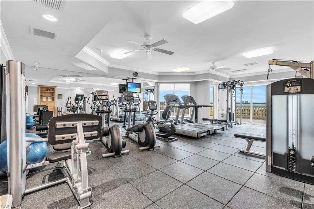Gym with ornamental molding and ceiling fan
