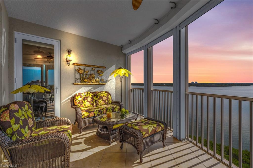 Sunroom featuring ceiling fan, plenty of natural light, and a water view