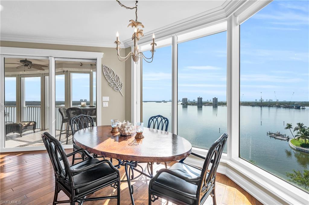 Dining space featuring ceiling fan, crown molding, hardwood / wood-style floors, and the mesmerizing Bay view