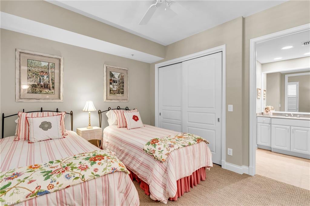 Guest Bedroom featuring light carpet, closet and private entrance to guest bathroom