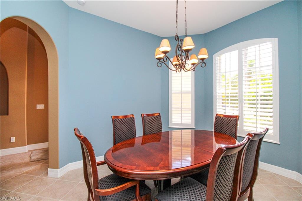 Tiled dining space featuring a chandelier