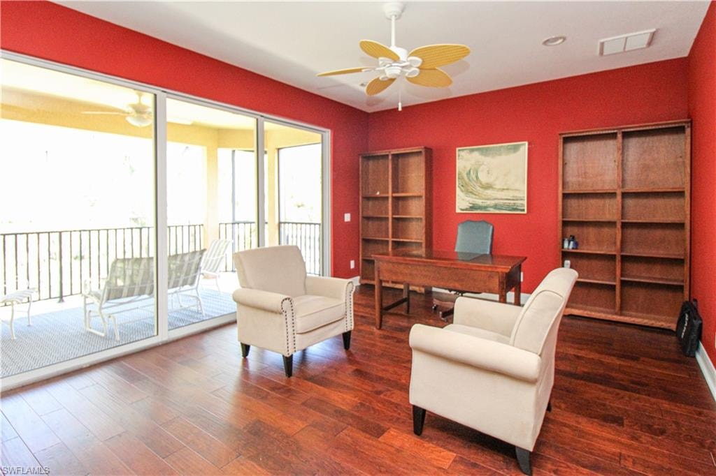 Sitting room with ceiling fan and hardwood / wood-style floors